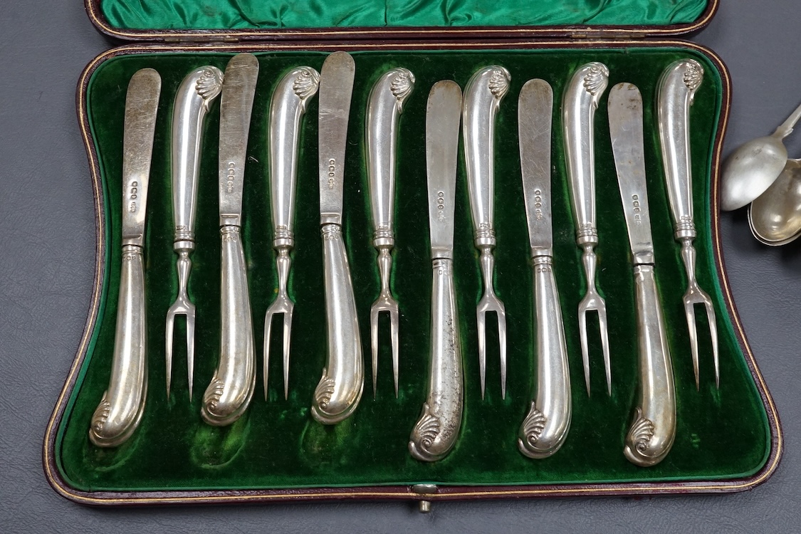 A cased set of six pairs of silver pistol handled dessert eaters by James Dixon & Sons, Sheffield, 1896, loaded, (a.f.), together with a small quantity of assorted silver flatware, 10oz.